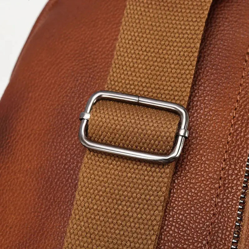 Leather chest bag by Simples Market, genuine top-grain brown leather with tan fabric crossbody strap and silver buckle