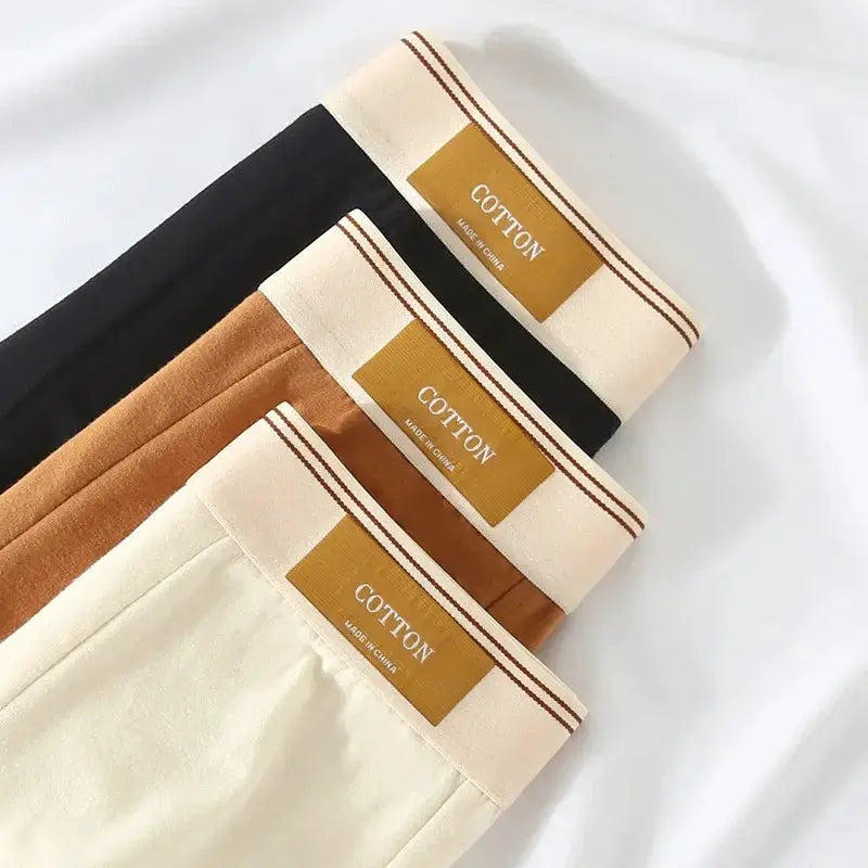 Men's cotton boxer shorts, 4-pack in black, brown, tan and cream; breathable solid colors.