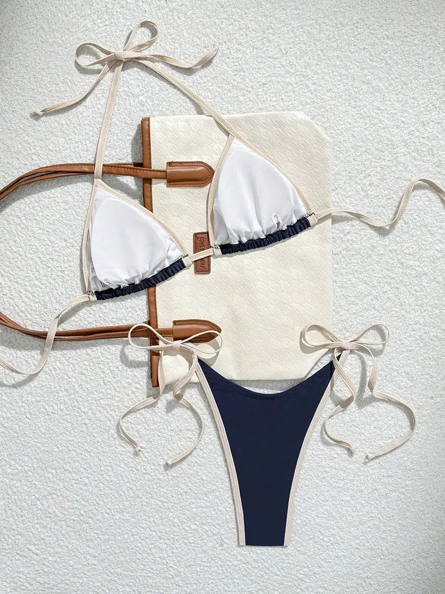 Simples Market sexy two-piece bikini set; white triangle top with beige strings and navy bottom with beige ties.