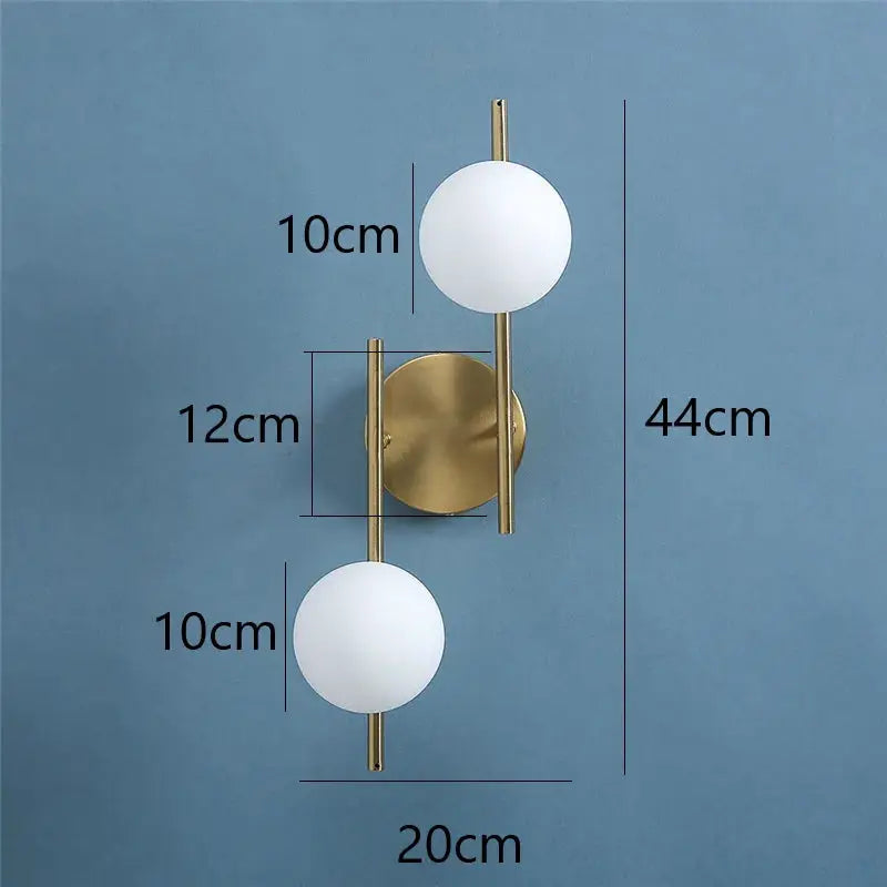 Simples Market pair of modern LED wall lamps with gold finish, milky glass spheres, and G9 bulbs