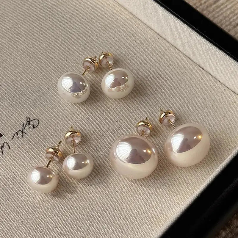 Sterling silver pearl earrings set; four white pearl studs in two sizes with gold-tone posts
