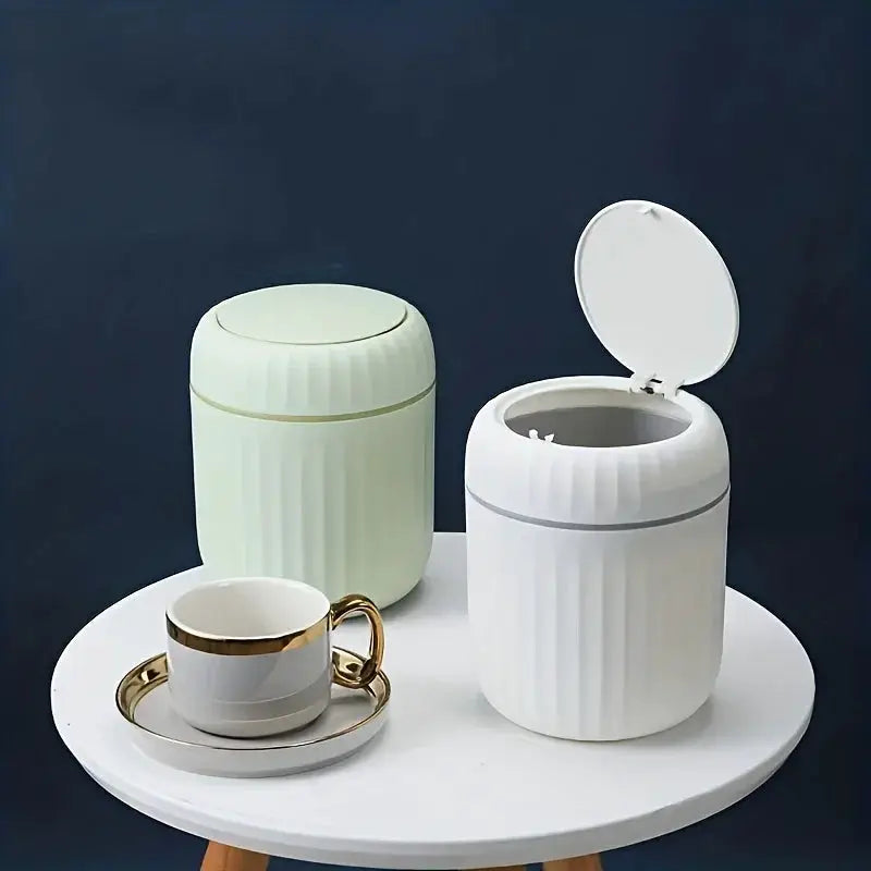 Mini desktop trash cans with lids, two-color plastic bins white and mint on a round table