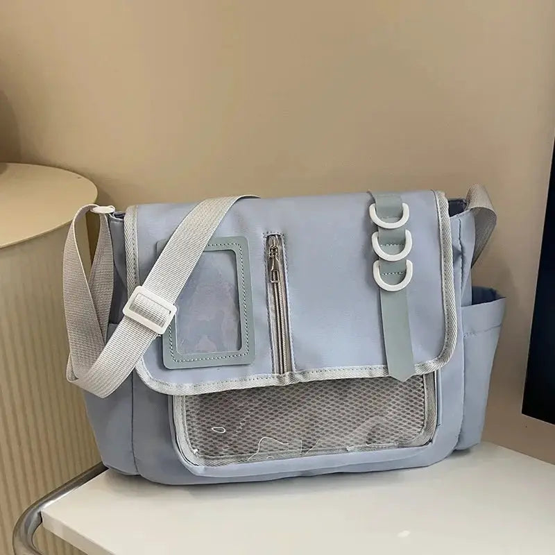 Itabag crossbody school bag, light blue with transparent window, zip pocket, mesh front pocket, white strap