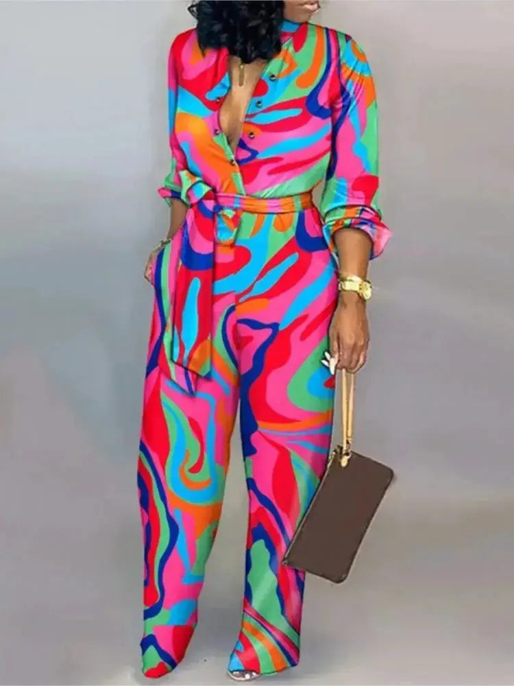 Women's colorful abstract-print jumpsuit with long sleeves, belt, button-front, wide-leg pants.