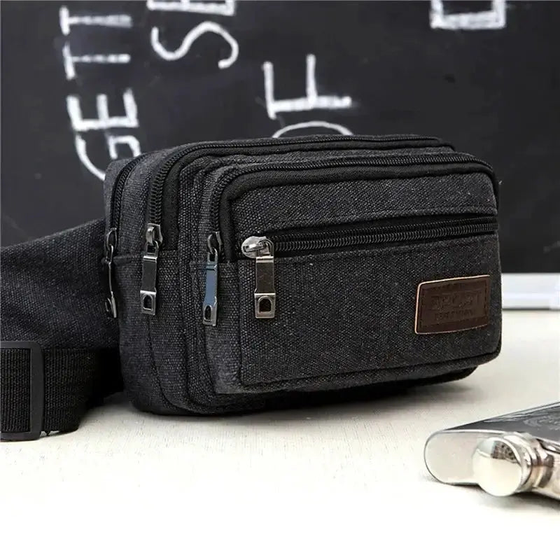 Canvas waist bag with three zip compartments in black; adjustable strap, durable high-capacity Simples Market pouch.