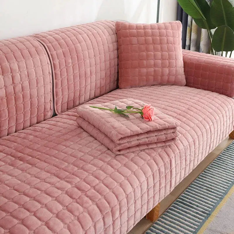 Velvet pink sofa cover with a matching quilted cushion on a plush living room sofa
