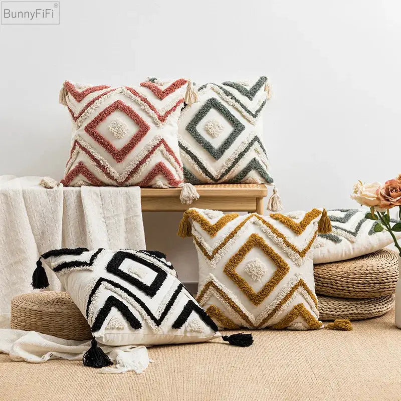 Pillow cover set of four from Simples Market with tufted diamond pattern and tassels in pink, green, black and mustard for sofa or bed.