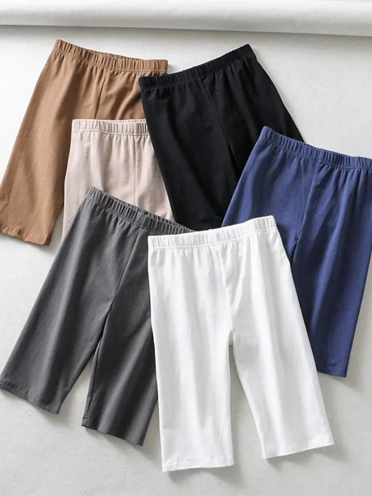 Biker shorts by Simples Market, elastic high-waist knee-length, in six colors: tan, beige, gray, black, blue, white.