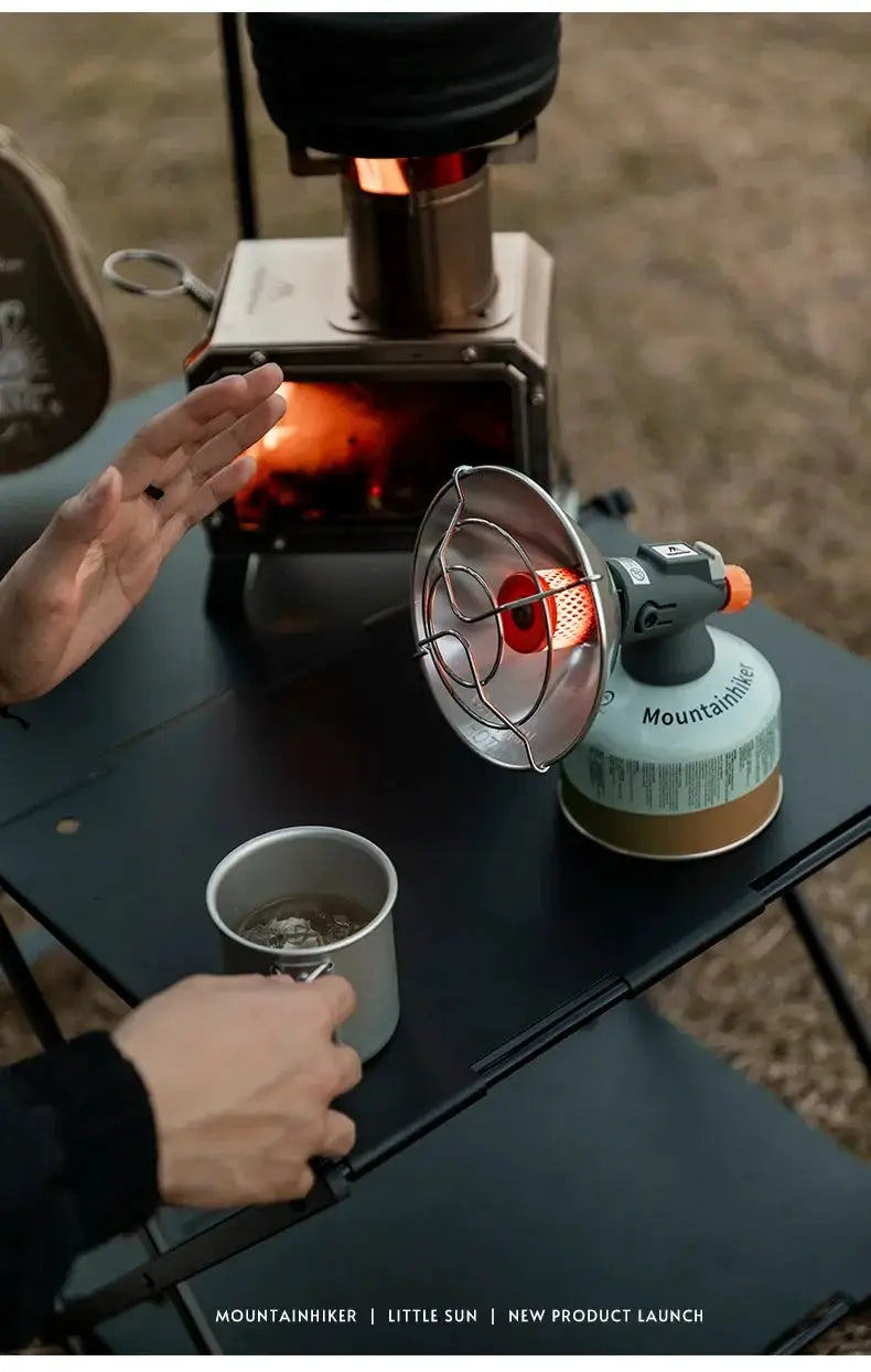 MountainHiker portable mini sun gas stove with silver burner and orange knob on a butane canister