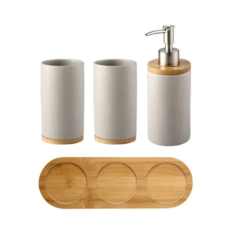 Ceramic bathroom accessories set, white with bamboo tray, 4 pieces including soap dispenser and two tumblers.