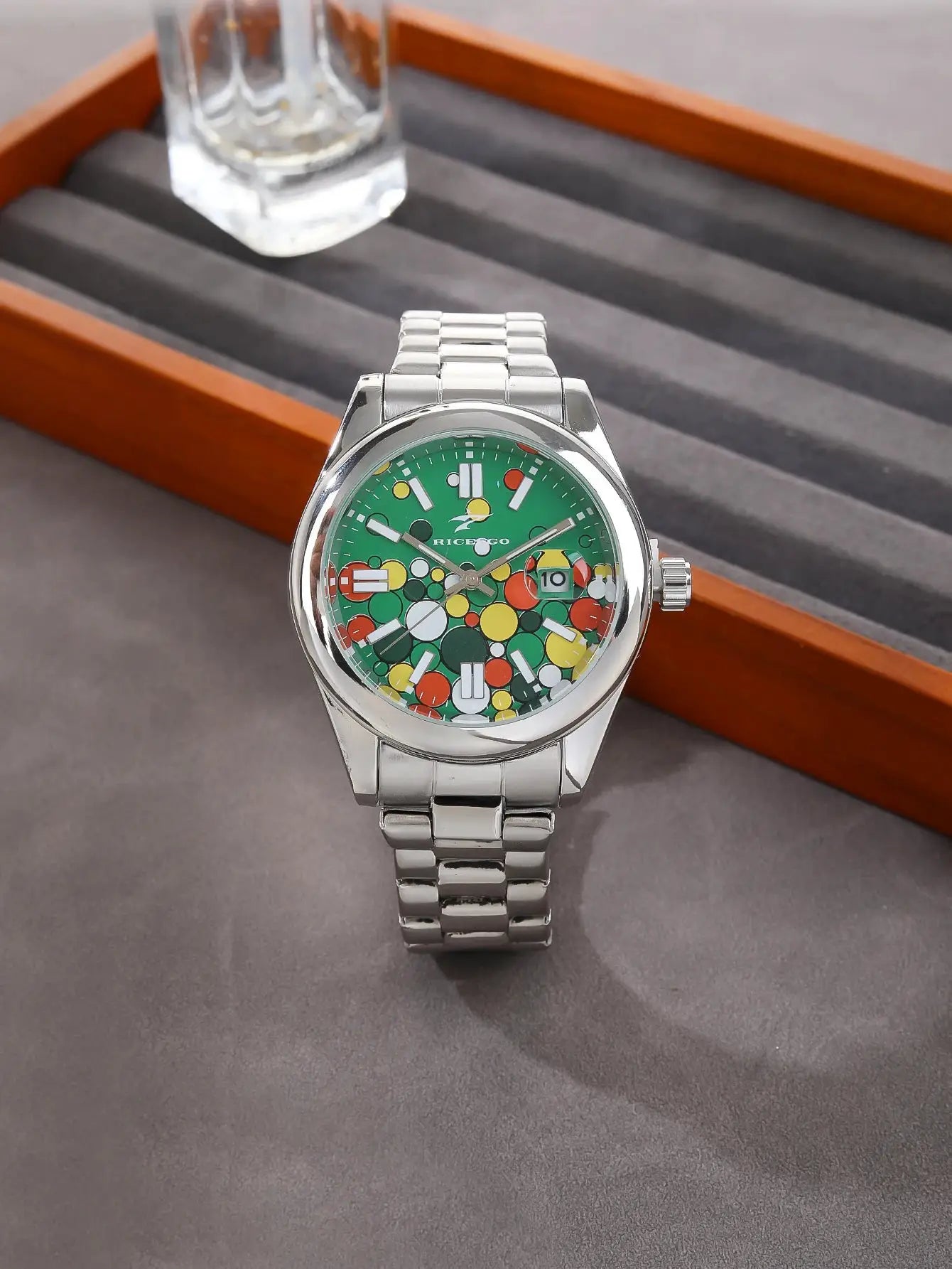 Men's stainless steel wristwatch by Simples Market with green dial and multicolor dot pattern; calendar date window