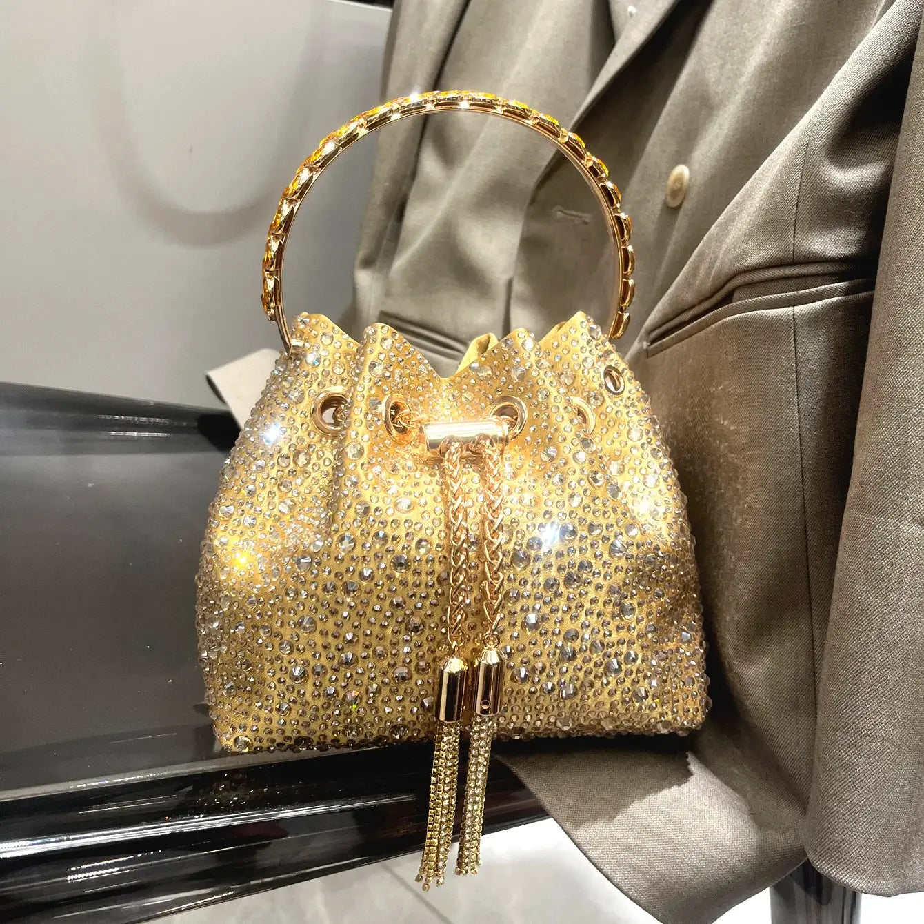 Gold rhinestone evening clutch with crystal-covered bucket bag and jeweled round handle