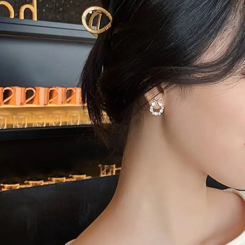Simples Market hollow-out round rhinestone bow stud earrings, gold-tone with clear crystals