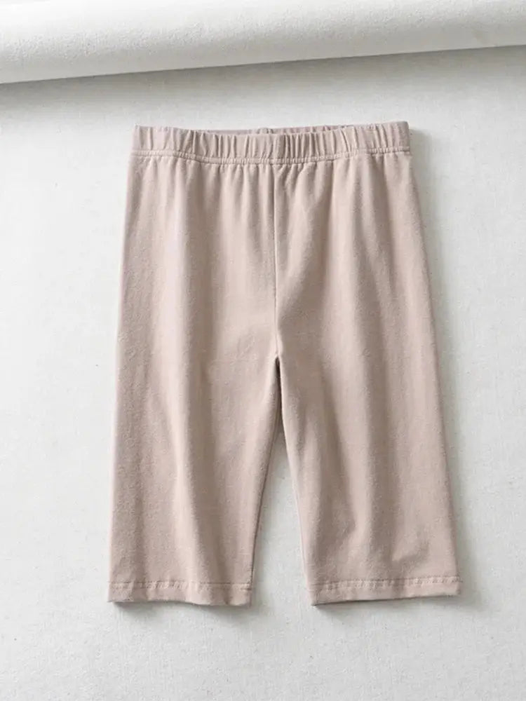 Women's knee-length beige biker shorts, high-waisted with elastic waistband