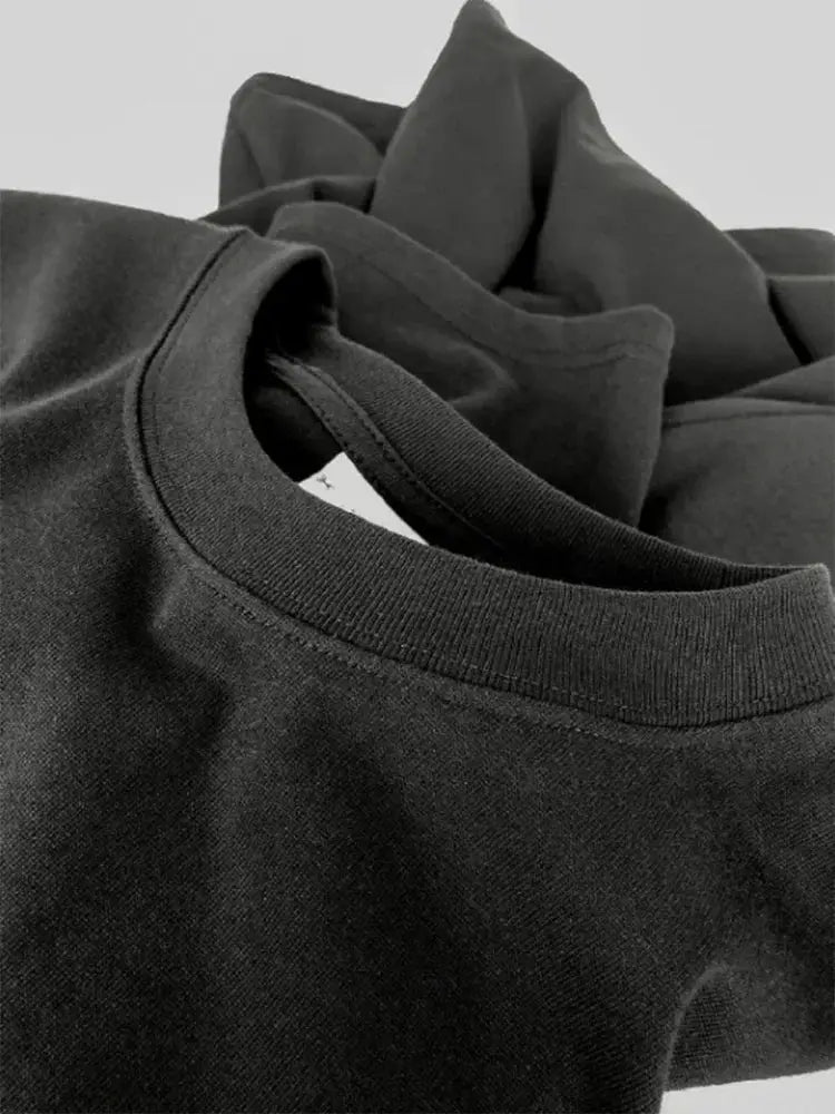 Black crewneck sweatshirt close-up of neckline, plain knit fabric
