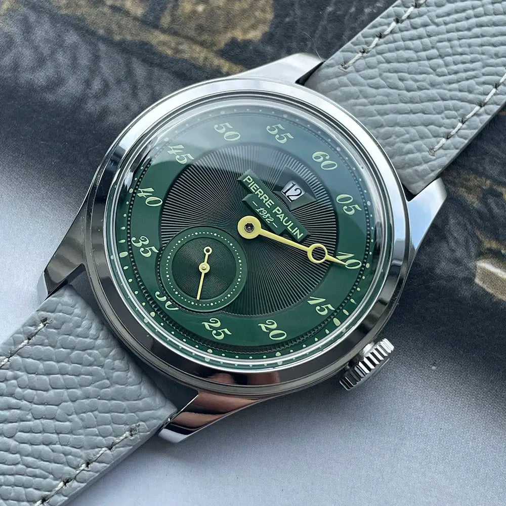 Pierre Paulin Jumping Hour men's watch with salmon dial, date window, stainless steel case, gray leather strap.