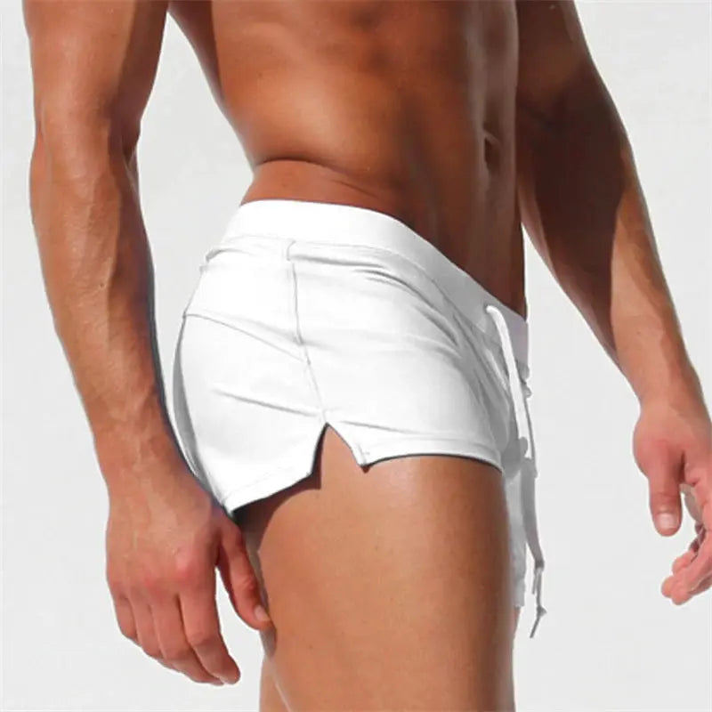 Men's white swim trunks with drawstring waist, quick-drying fabric, side curved hem