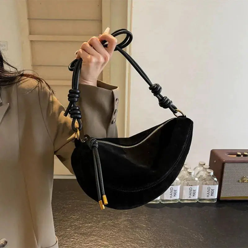 Simples Market faux suede shoulder bag, black curved crossbody with knotted handle and gold zipper