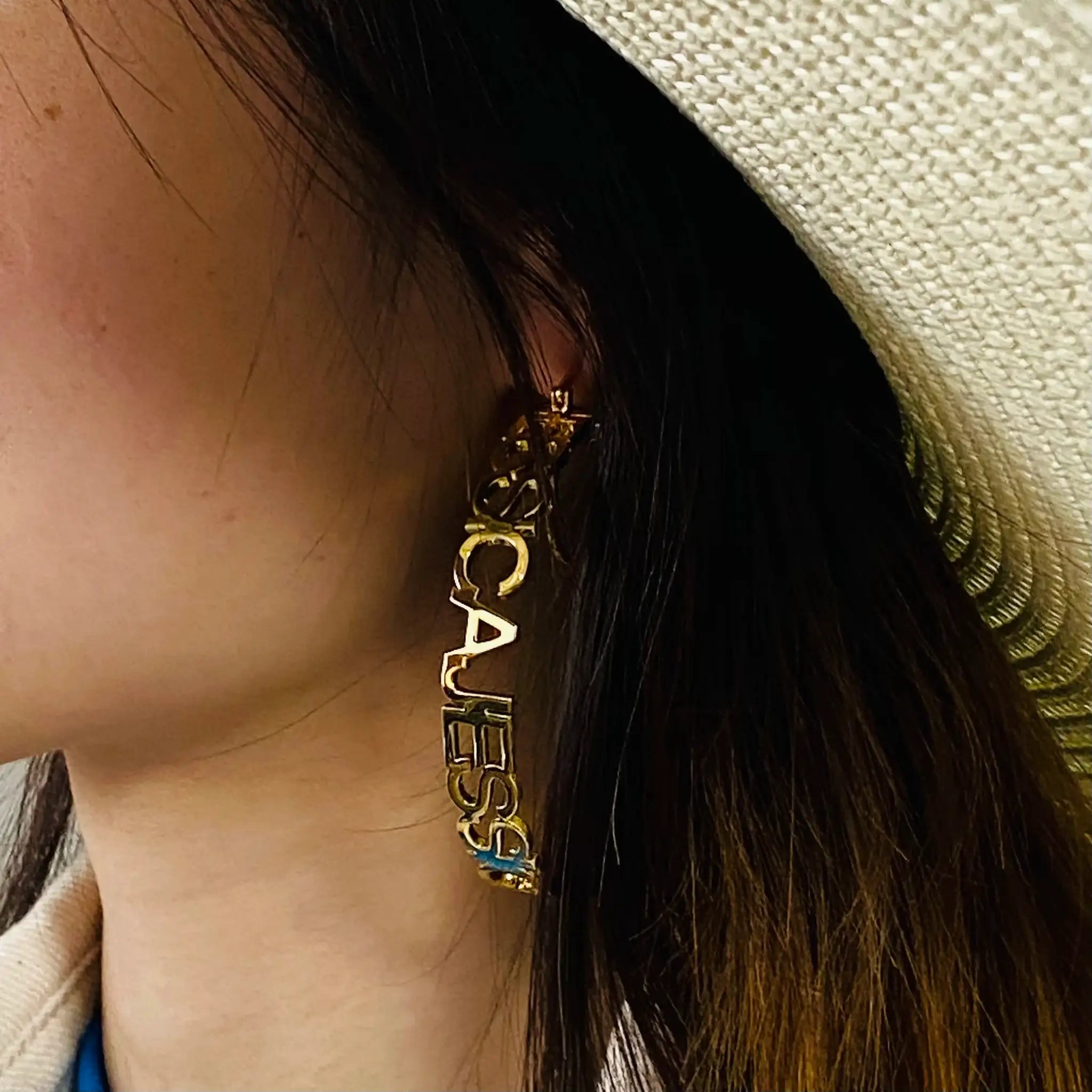 Custom name hoop earrings in gold stainless steel with large circle lettering by Simples Market
