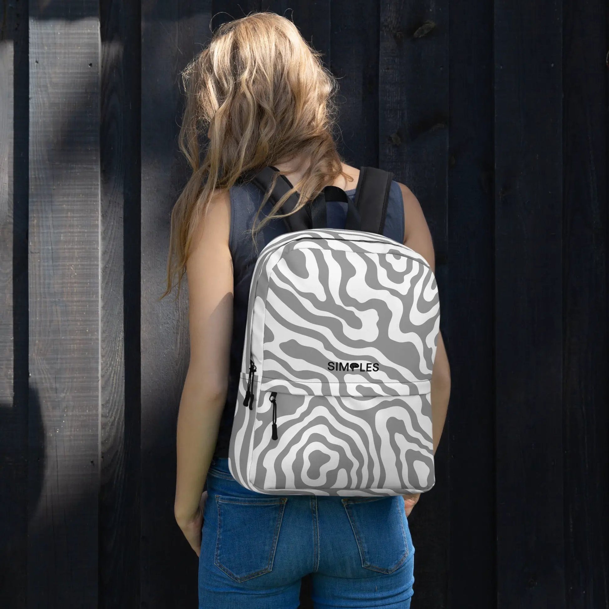Backpack with gray zebra-print pattern and black straps by Simples Market