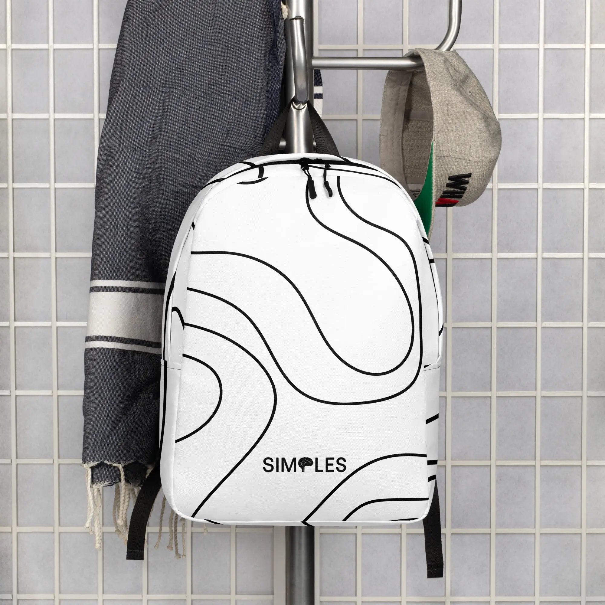 Minimalist Backpack by Simples Market; white with black swirl pattern and visible Simples Market logo.