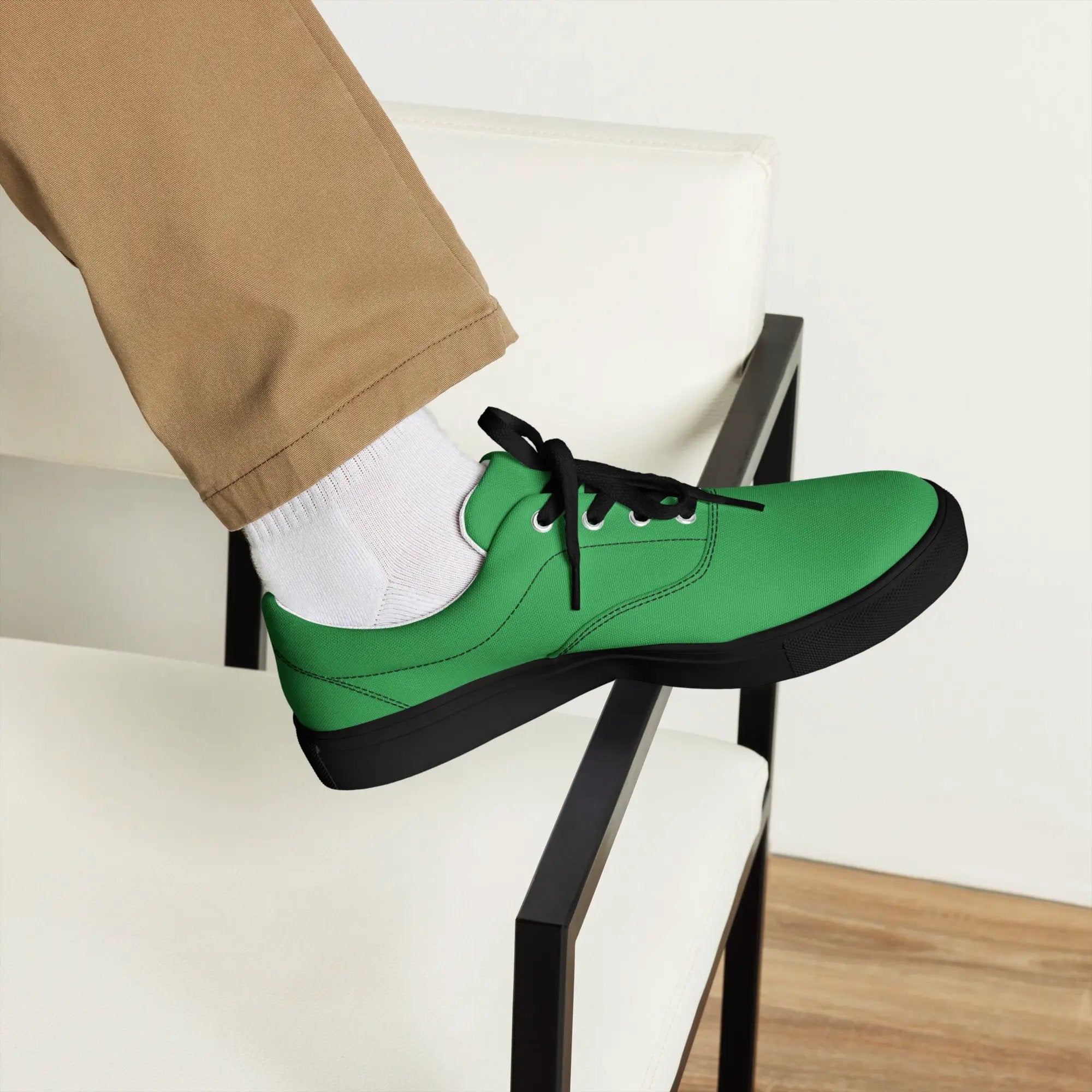 Men's lace-up canvas shoes in green with black sole, worn with white socks and beige pants