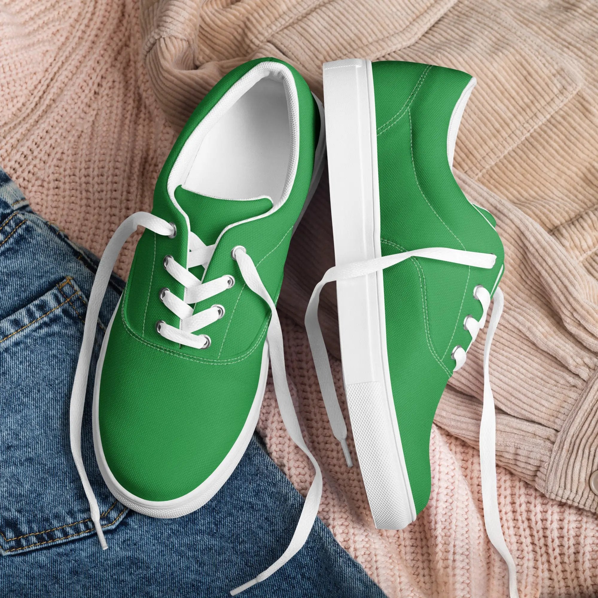 Men’s green canvas lace-up sneakers with white soles on a pink knit blanket