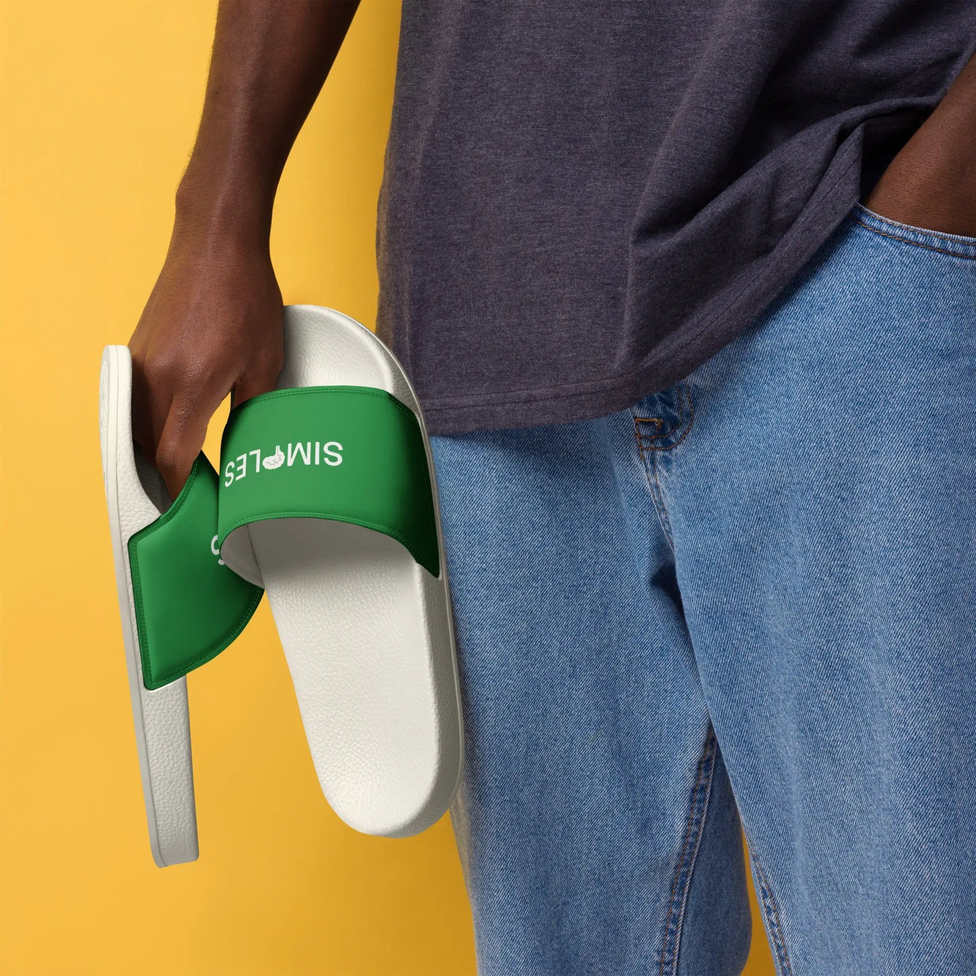 Men's Simples Market slides with green strap and white sole, shown with blue jeans.
