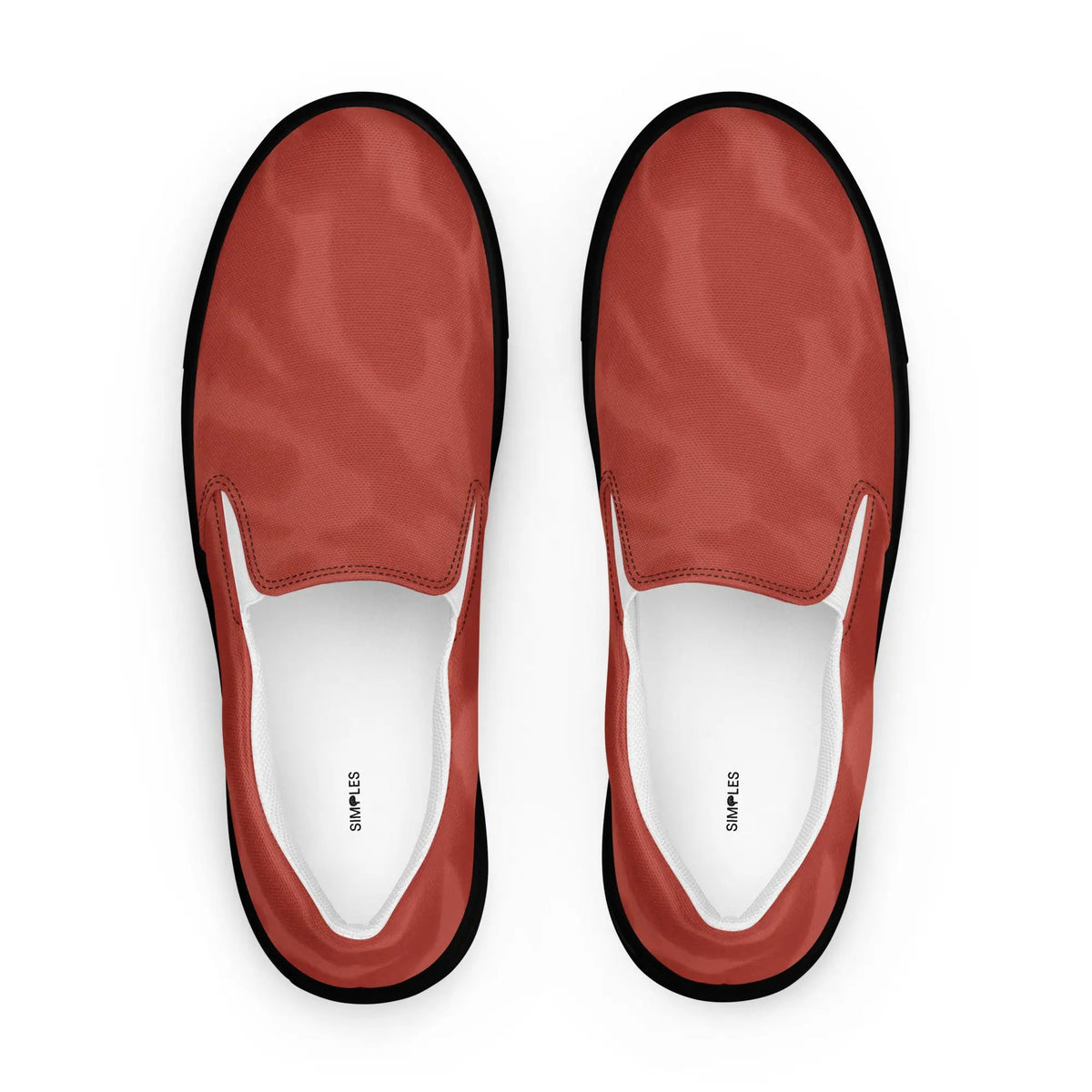 Pair of men's red canvas slip-on shoes by Simples Market with white interior.