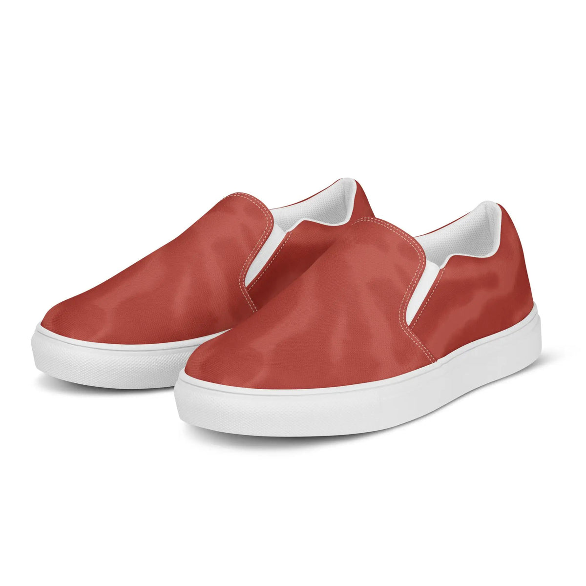 Two red canvas slip-on shoes with white soles by Simples Market