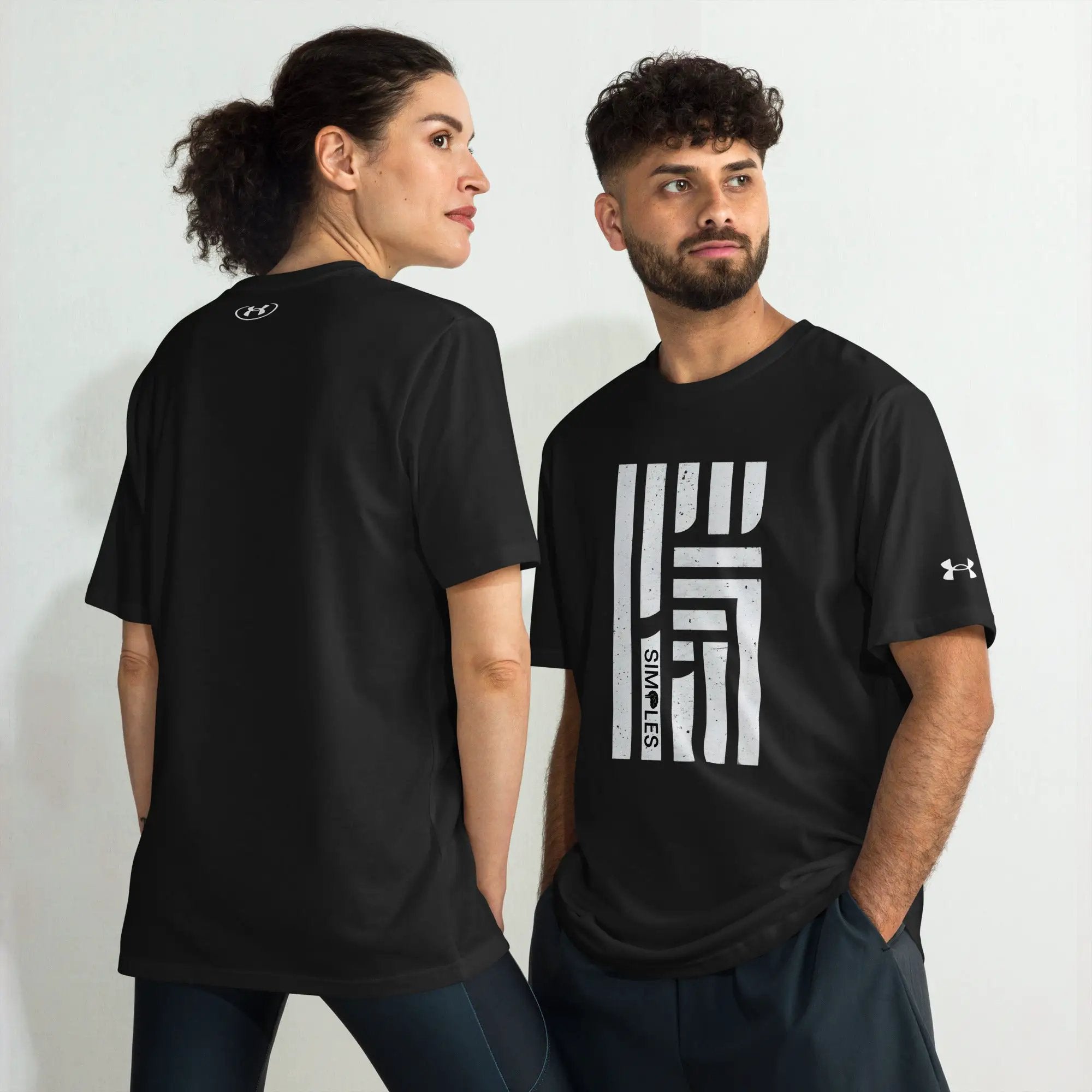 Under Armour athletic t-shirt on two models, black with visible UA logos.