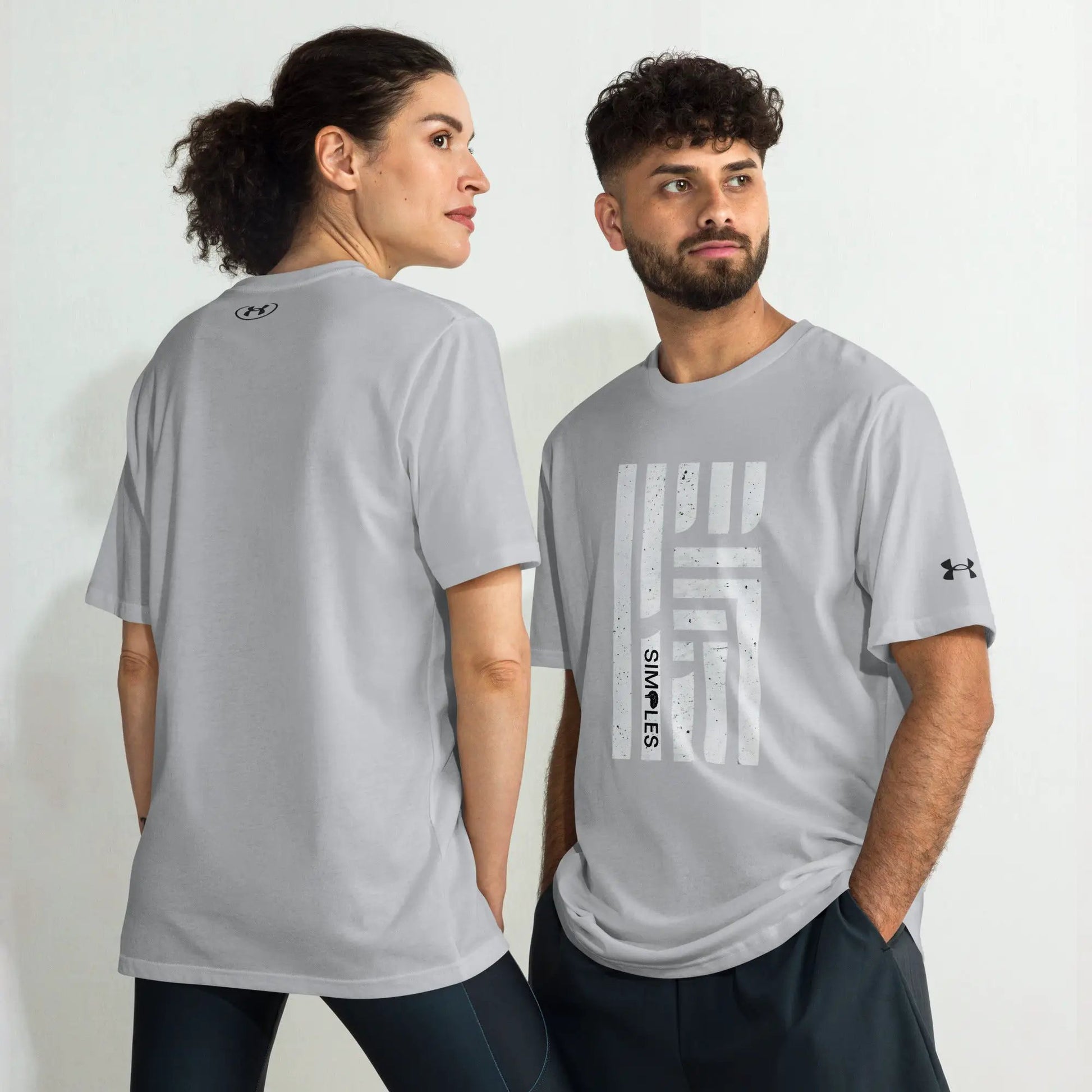Under Armour athletic t-shirt worn by two models in light gray with visible UA logos.