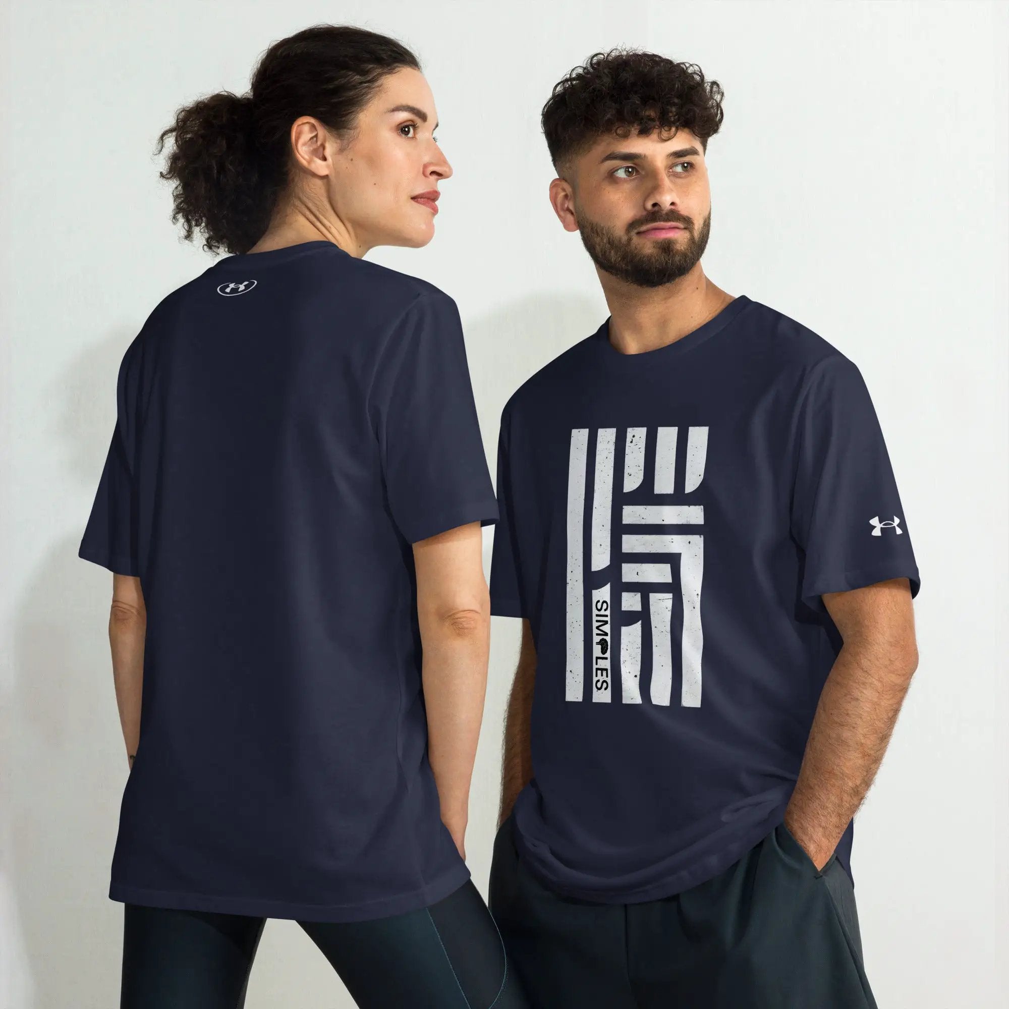 Under Armour athletic t-shirts in navy worn by two models; visible back neck logo and front print.