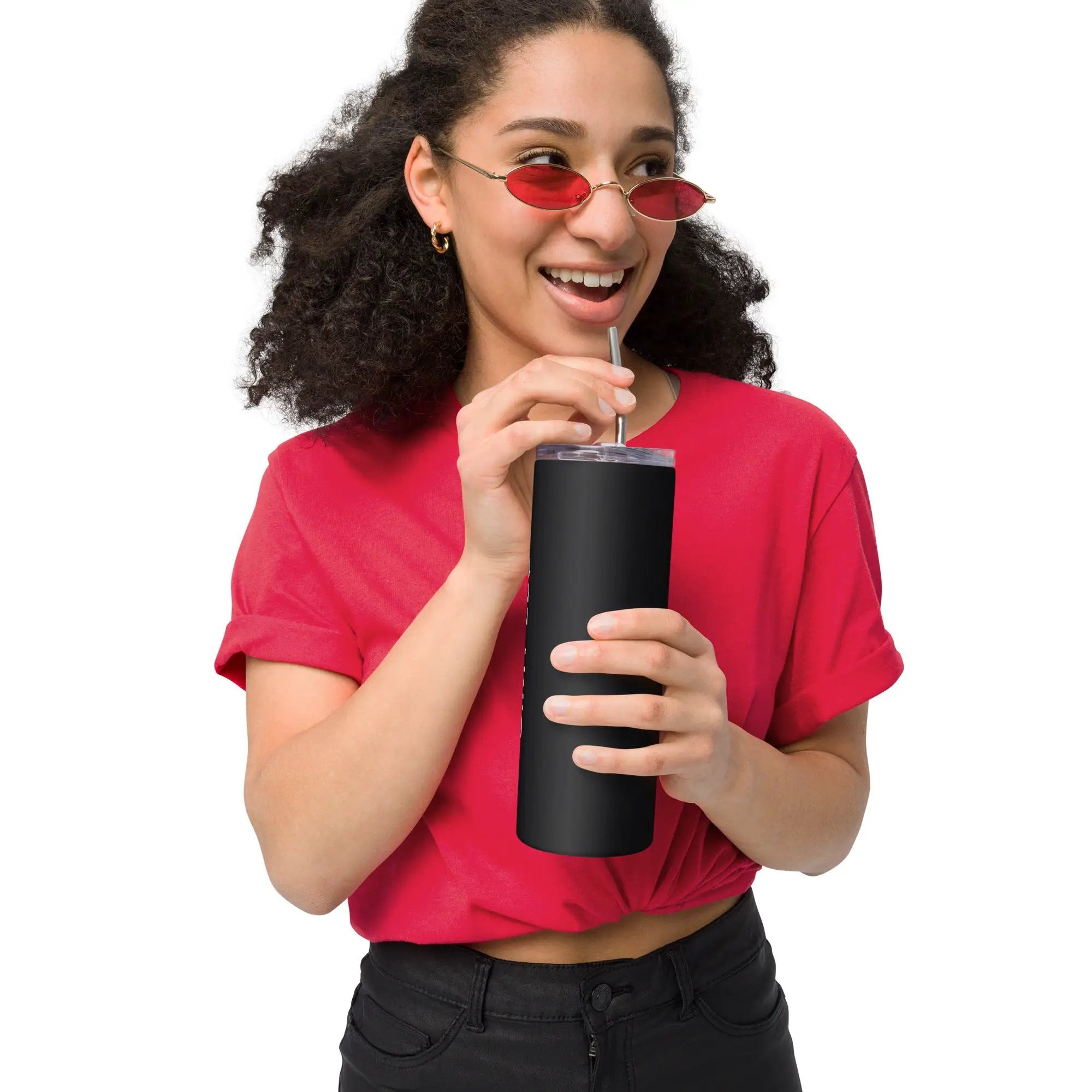 Stainless steel tumbler with matte black finish held by smiling person in a red shirt.
