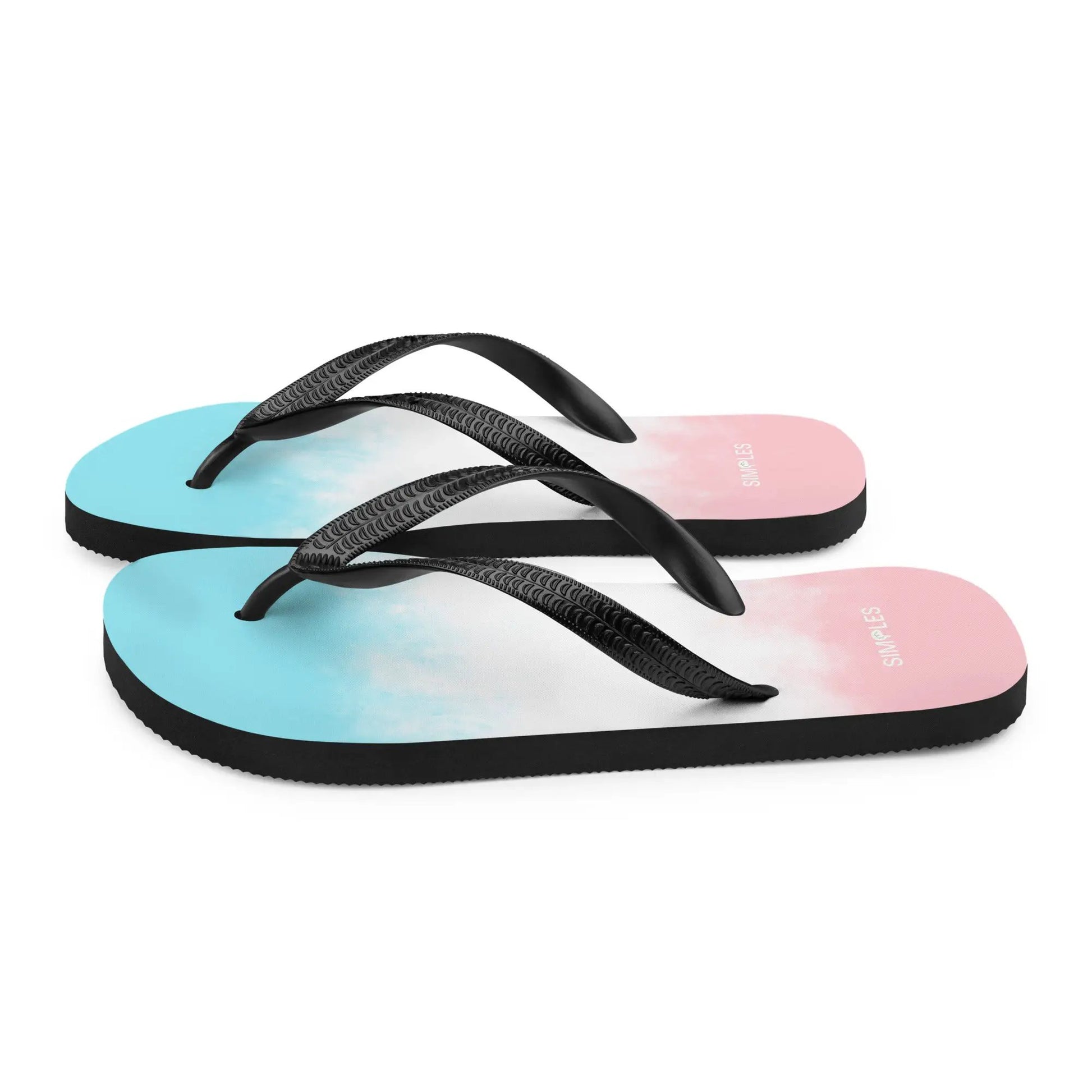 Flip-flops by Simples Market; three sandals with black textured straps and gradient blue to pink soles.