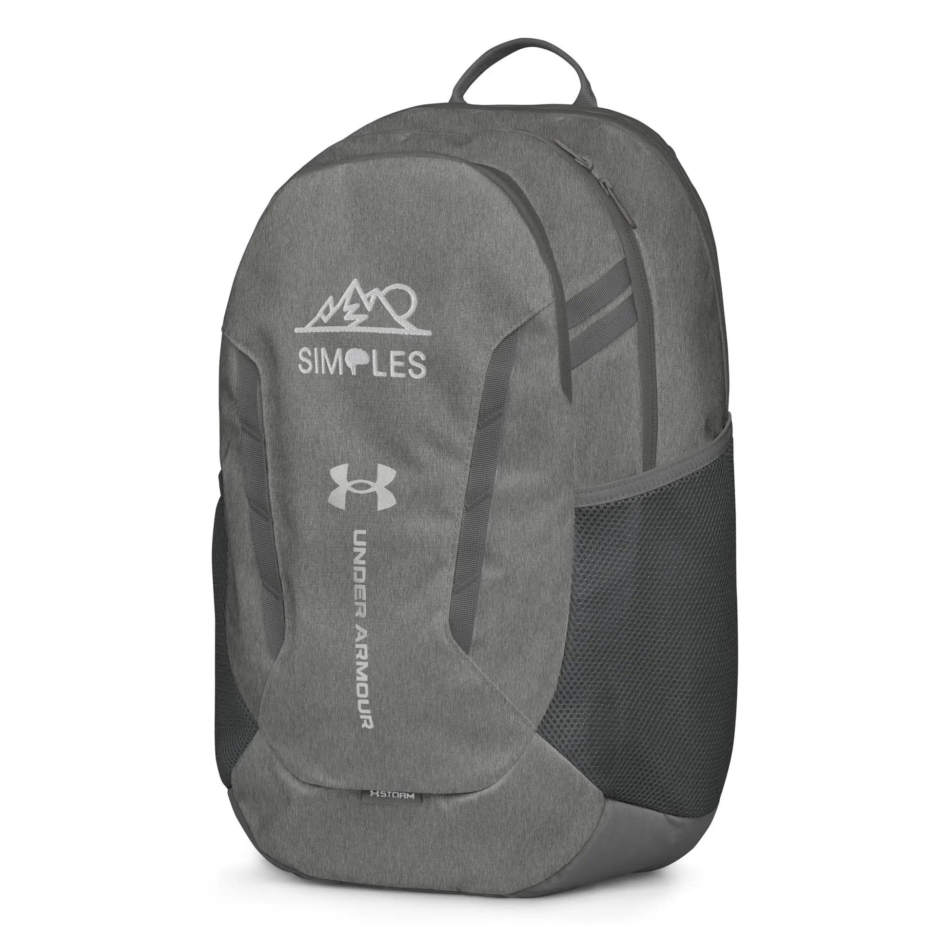 Under Armour backpack, gray fabric with front zip pockets and top carry handle, UA logo visible