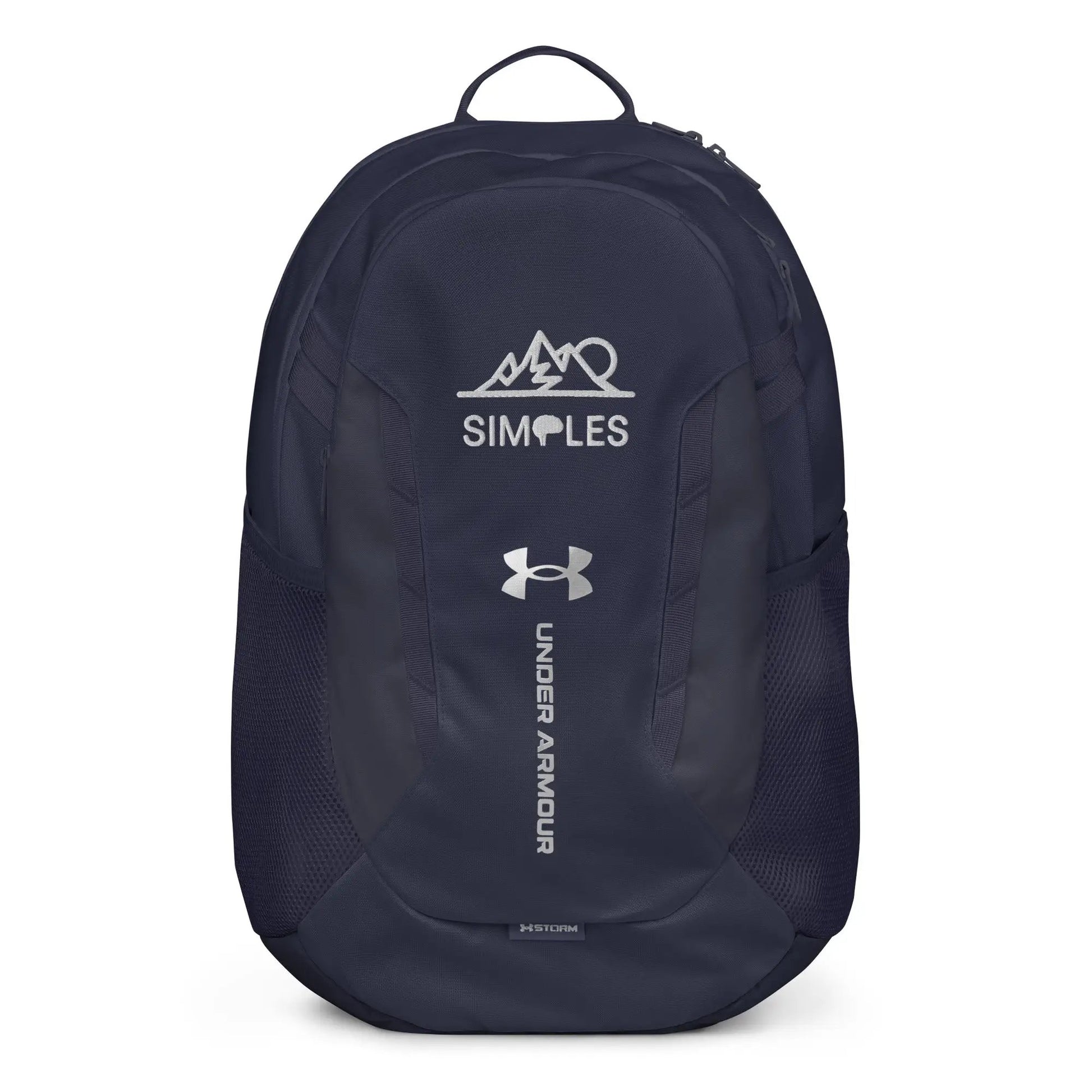 Under Armour backpack in navy with white UA logo and Simples Market branding on front.