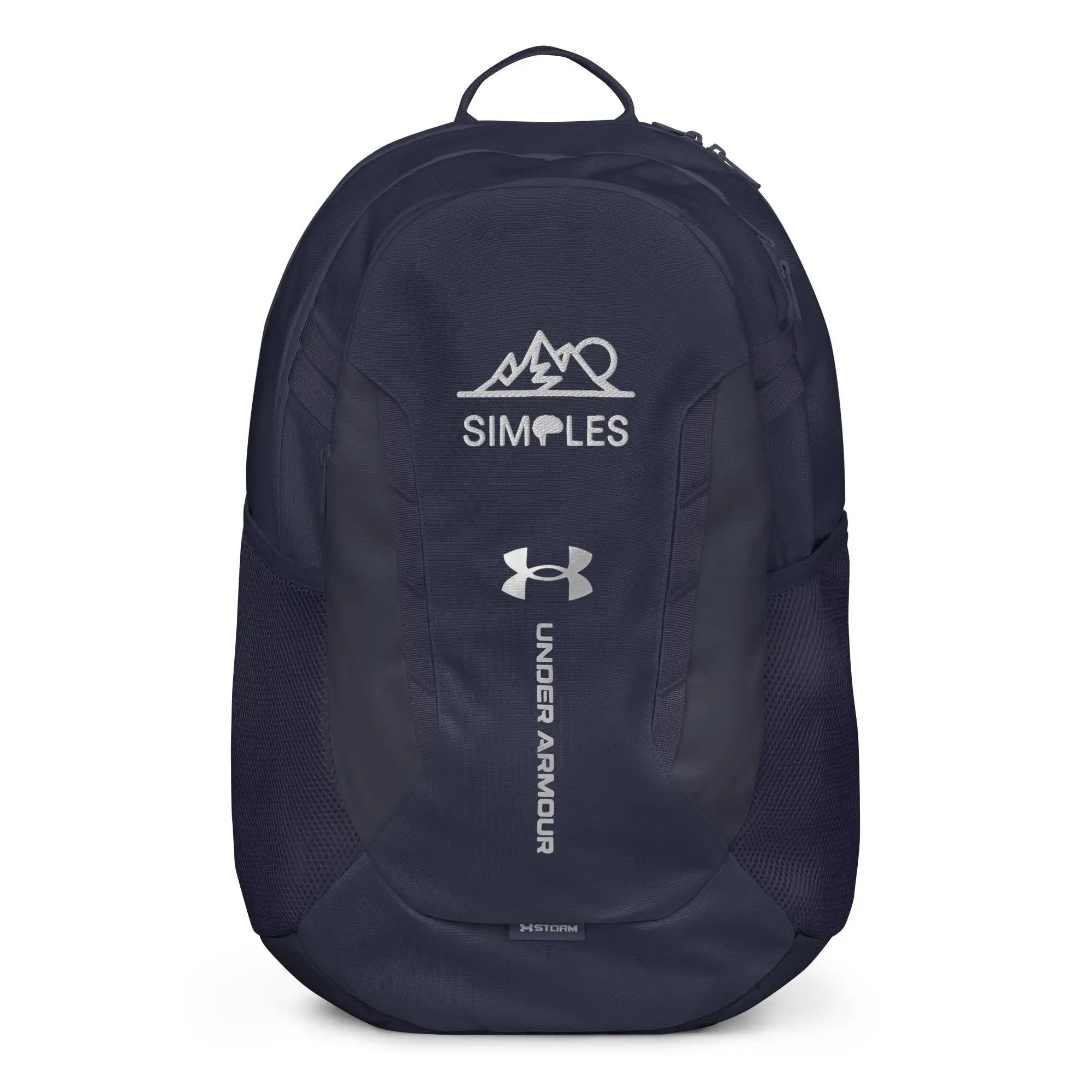Under Armour backpack in navy with white UA logo and Simples Market branding on front.