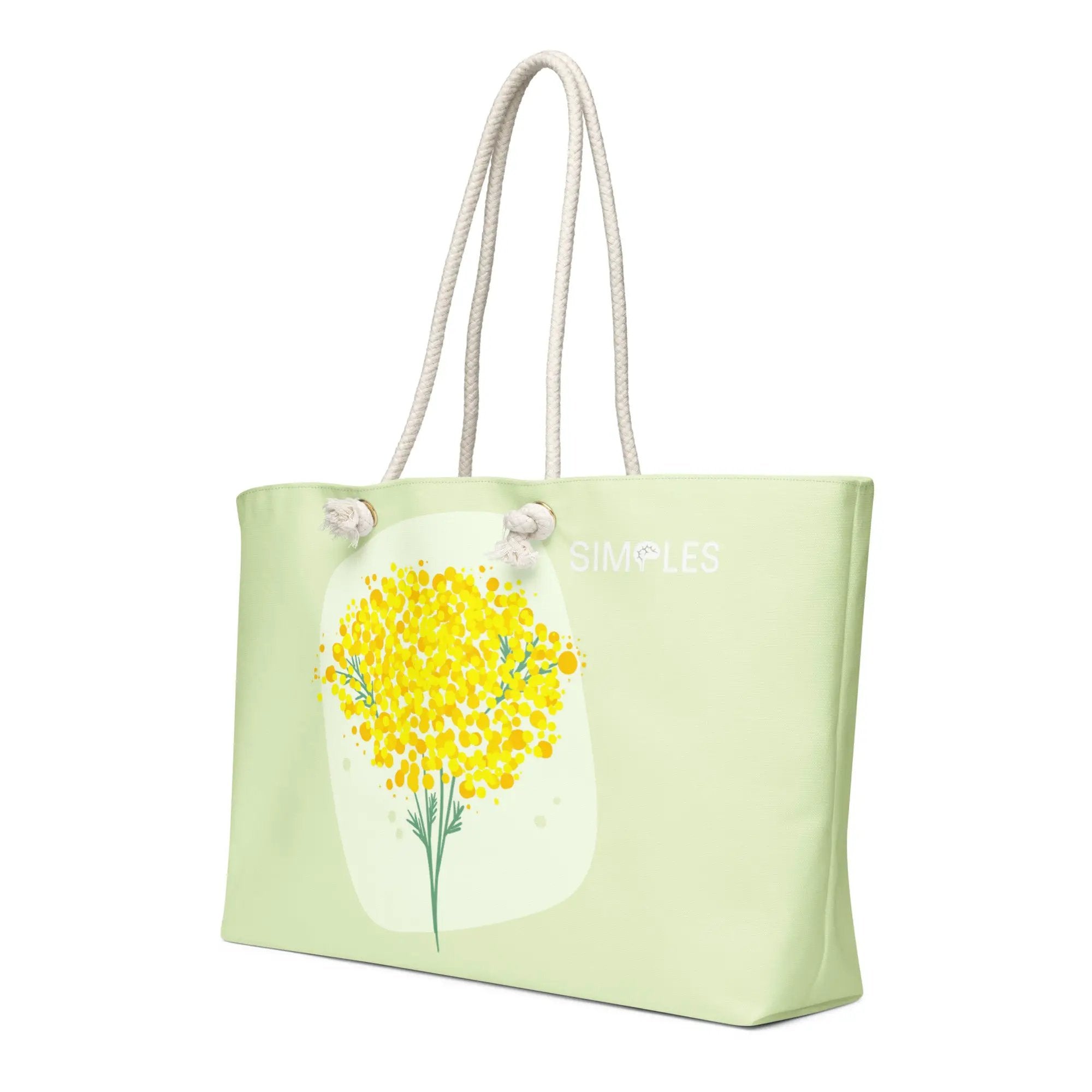 Oversized weekender bag by Simples Market; pastel green tote with rope handles and yellow floral print.