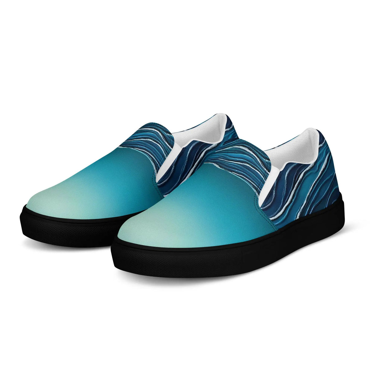 Pair of women's slip-on canvas shoes by Simples Market; teal uppers with blue pattern, white lining, black sole.