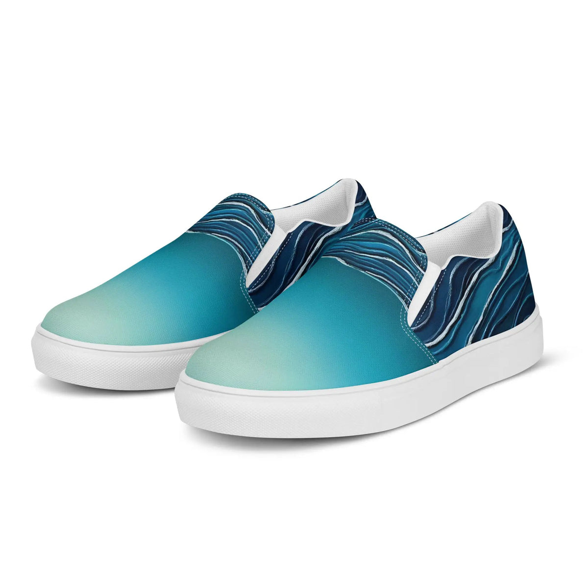Pair of women’s slip-on canvas shoes in teal-to-blue gradient with white soles